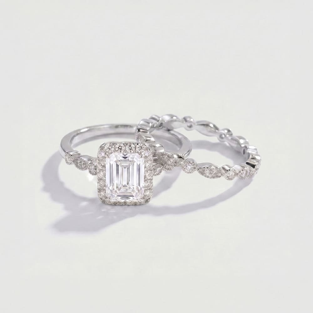 Diamond ring with a rectangular center stone on a light gray background