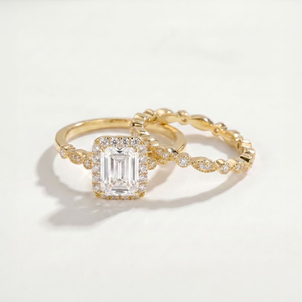 Gold ring with a large diamond and a smaller diamond-studded band on a light background
