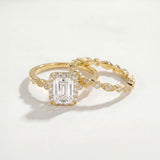 Gold ring with a large diamond and a smaller diamond-studded band on a light background