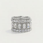 Stack of silver rings with gemstones on a light gray background