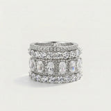 Stack of silver rings with gemstones on a light gray background