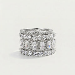 Stack of silver rings with gemstones on a light gray background