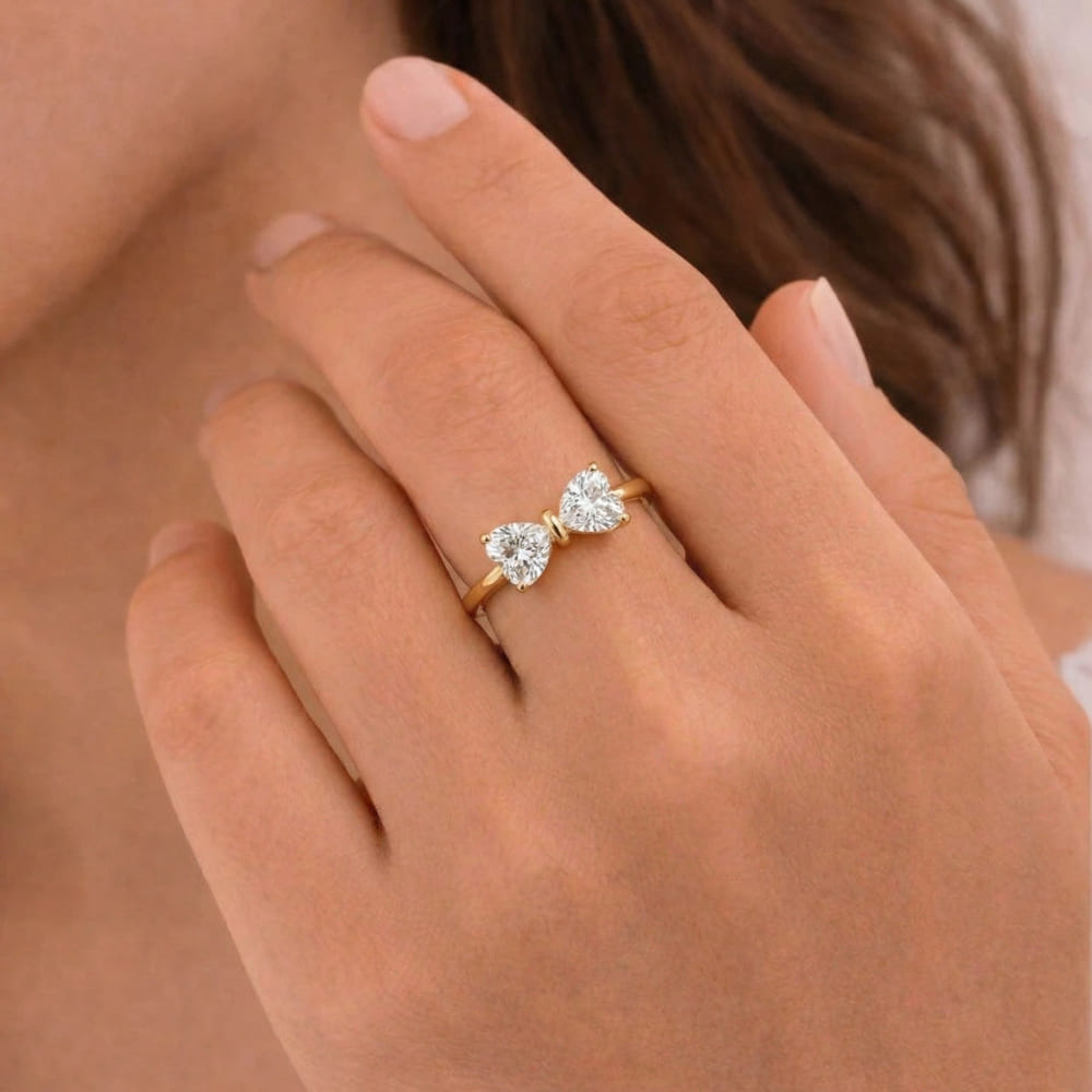Rose gold heart-shaped diamond ring on a hand