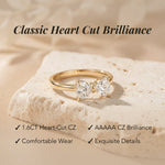 Gold ring with heart-cut gemstones on a beige stone, with text highlighting features.