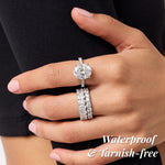 Close-up of a hand wearing two diamond rings with 'Waterproof & Tarnish-Free' text.