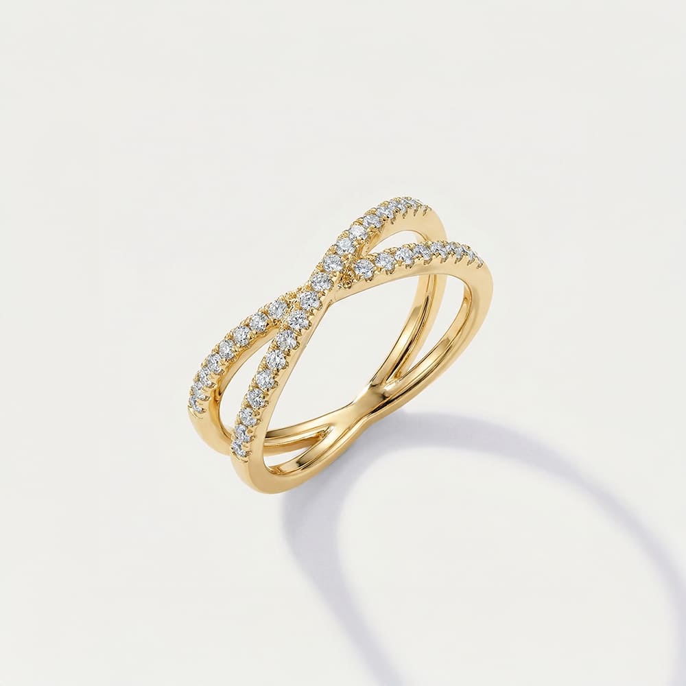 Gold ring with diamond accents on a light gray background