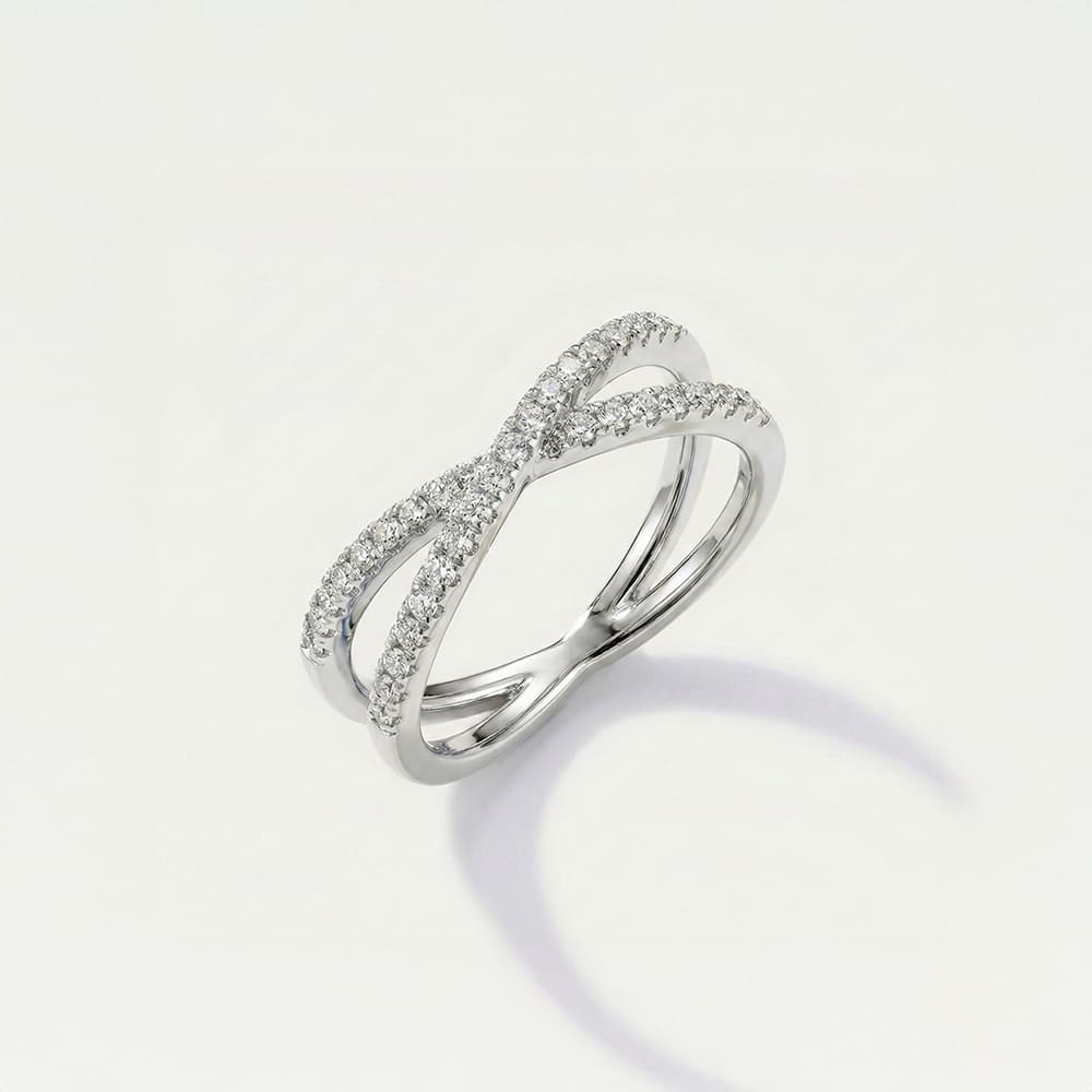 Silver ring with diamond accents on a light gray background