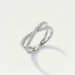 Silver ring with diamond accents on a light gray background